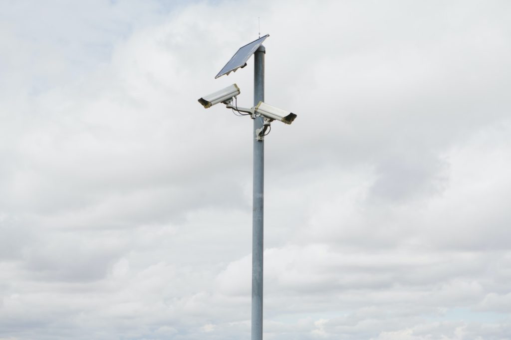 A solar powered surveillance camera on a pole.